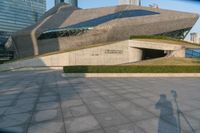 a stone building has a modern style architecture in it's centerpiece, as seen from the plaza