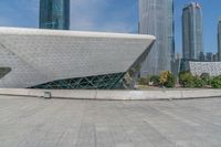 an open air area in front of buildings and a big triangle shaped structure on top