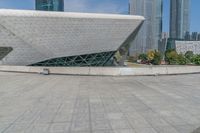 an open air area in front of buildings and a big triangle shaped structure on top