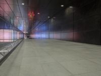 the floor of an underground tunnel is filled with lights and a metal railing that stretches right into the ground