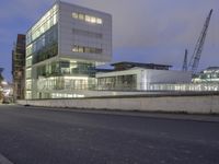 a large building with a lot of glass windows and a bike parked on the street