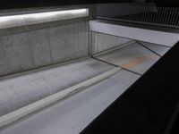 concrete steps are next to a wall and door with a black handle and some white cement