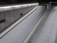 concrete steps are next to a wall and door with a black handle and some white cement