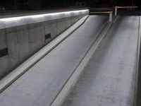 concrete steps are next to a wall and door with a black handle and some white cement