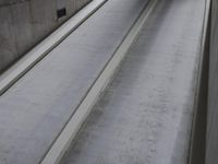 concrete steps are next to a wall and door with a black handle and some white cement