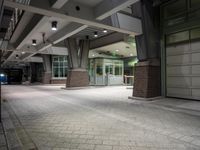 an empty parking garage with lots of windows on one side and floor tiles on the other