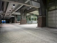 an empty parking garage with lots of windows on one side and floor tiles on the other