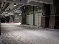 an empty parking garage with lots of windows on one side and floor tiles on the other