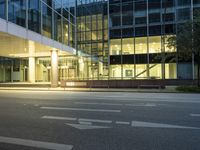 the entrance of a modern office building with several arrows pointing in opposite directions down a city street