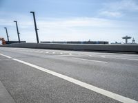 a car driving on a road through the airport in the sun with an airplane in the sky