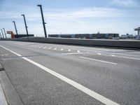 a car driving on a road through the airport in the sun with an airplane in the sky