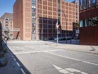 a large building sitting next to a tall red brick building with glass windows is shown
