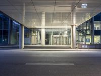 a modern entrance to an office building at night time in the city of london, england