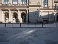 an empty city street has been deserted in the afternoon sun while a person rides a bicycle