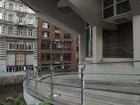 some buildings are next to a body of water and a bridge with people on it