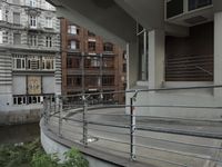 some buildings are next to a body of water and a bridge with people on it