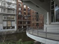 some buildings are next to a body of water and a bridge with people on it