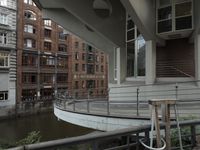 some buildings are next to a body of water and a bridge with people on it