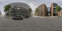 two circular images depicting the exterior of buildings, and two cars parked on a street