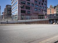 an empty city street with buildings and a truck on the side of it next to rocks