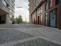 a street that has several different buildings in it and some people are on the sidewalk