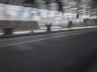 an image of a blurry picture of the road below them in motion on a cellphone