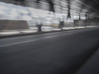 an image of a blurry picture of the road below them in motion on a cellphone