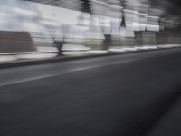 an image of a blurry picture of the road below them in motion on a cellphone