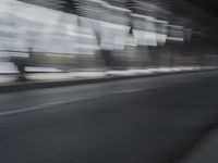 an image of a blurry picture of the road below them in motion on a cellphone