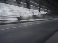 an image of a blurry picture of the road below them in motion on a cellphone