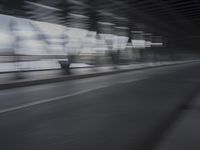 an image of a blurry picture of the road below them in motion on a cellphone