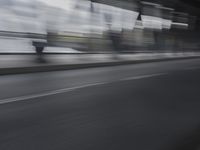 an image of a blurry picture of the road below them in motion on a cellphone