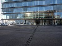 an airport parking lot with a plane parked outside the terminal building of it and a boat out in the harbor