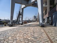 an old looking railroad track near the water and buildings and stairs going up to the roof