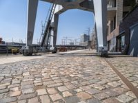 an old looking railroad track near the water and buildings and stairs going up to the roof