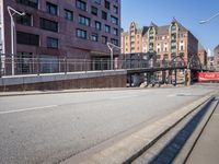 an empty city street with buildings and a truck on the side of it next to rocks