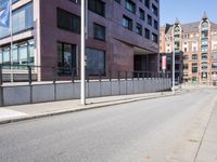 an empty city street with buildings and a truck on the side of it next to rocks