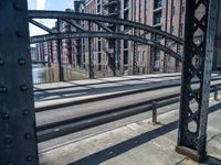 the rail of an old train track with an arch in front of it that looks like a bridge