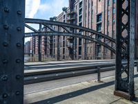 the rail of an old train track with an arch in front of it that looks like a bridge