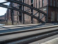 a very big wide street with some train tracks and a lot of tall buildings in the background