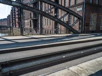 a very big wide street with some train tracks and a lot of tall buildings in the background