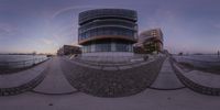 a photo taken of the bottom of a circular object in the sky with buildings in the background