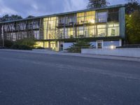 an image of a building lit up at night time from the street below the stairs