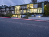 an image of a building lit up at night time from the street below the stairs