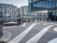 the sidewalk is painted with decorative designs near a building's windows and bicycle racks