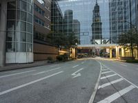 a empty street with some tall buildings in the background near the intersection of a busy city street