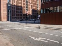 an empty city street with buildings and a truck on the side of it next to rocks