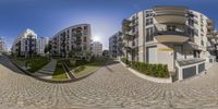 a 360 - turn photograph of a brick street in front of a building on the other side of the street