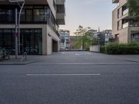 a empty parking lot outside a large brick building on a street corner in the city