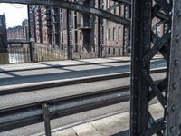 a view of the inside of an old city bridge from an empty train track,